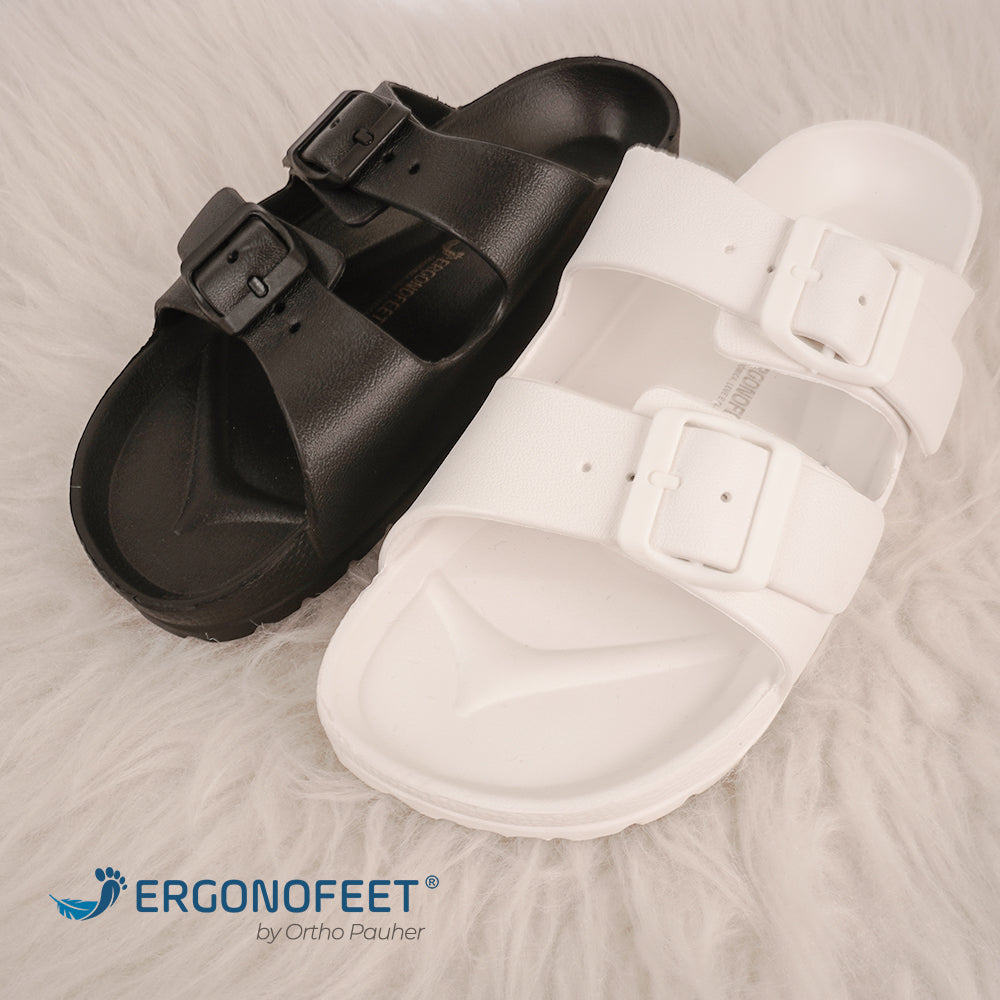 A imagem mostra duas sandália ortopédica Ergonofeet, na cor preta e na cor branca